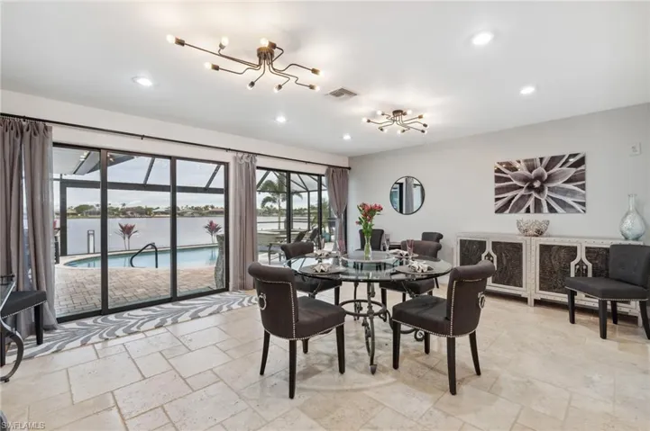 Dining space with a water view and an inviting chandelier