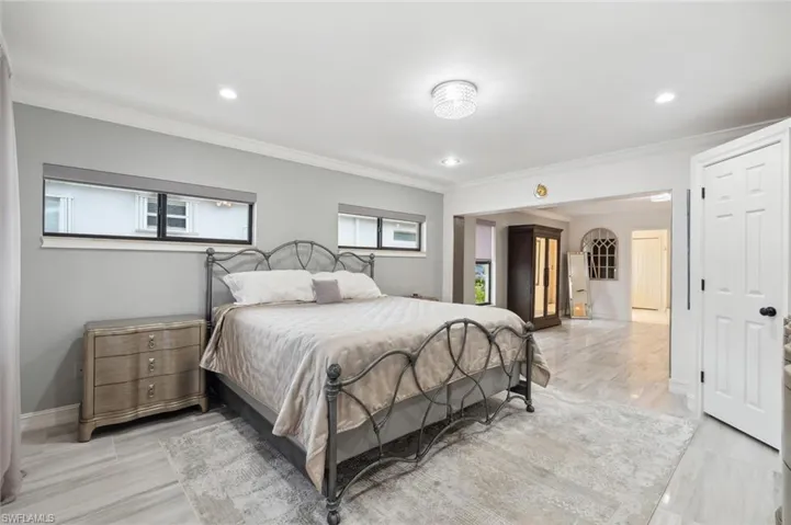 Bedroom featuring light wood-type flooring and crown molding