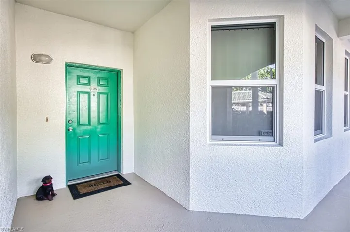 Property entrance featuring stucco siding