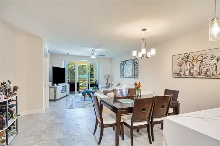 Dining area featuring a ceiling fan and a chandelier