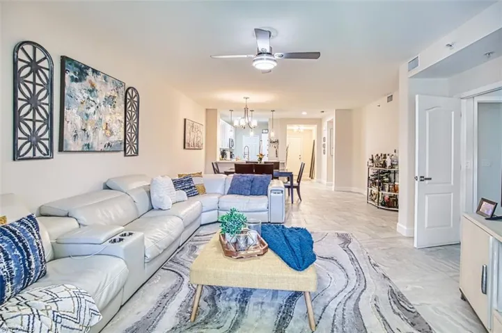 Living area with ceiling fan and a chandelier