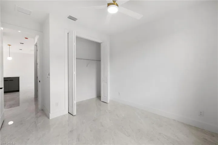 Unfurnished bedroom with a closet and a ceiling fan
