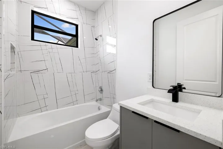 Full bathroom featuring vanity and shower / washtub combination
