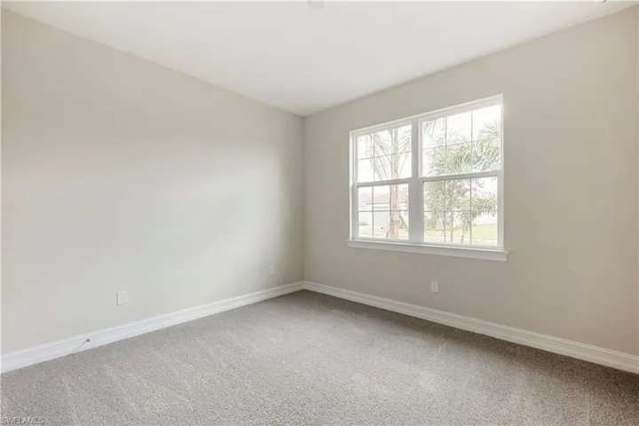 Spare room featuring carpet