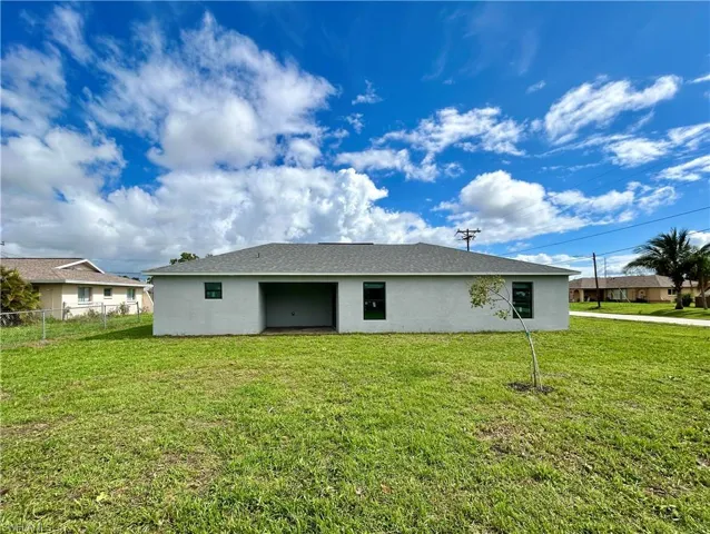 Rear view of house with a lawn