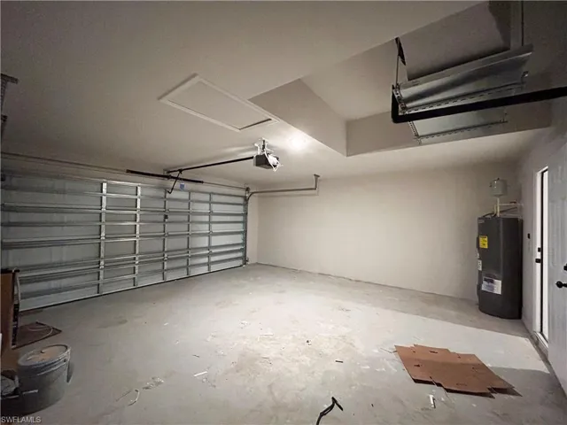 Garage with a garage door opener and electric water heater
