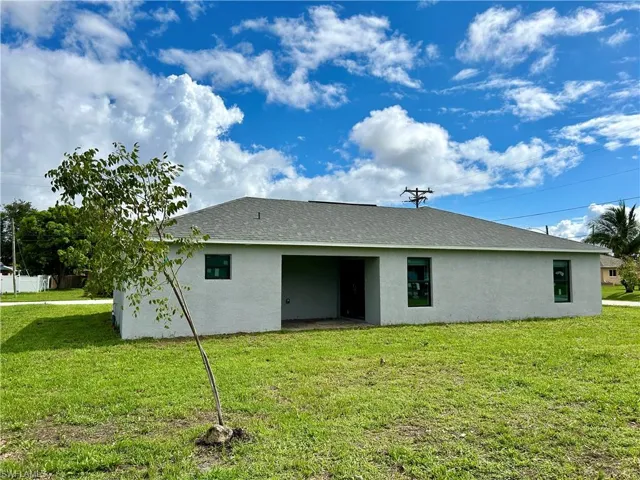 Back of property featuring a yard