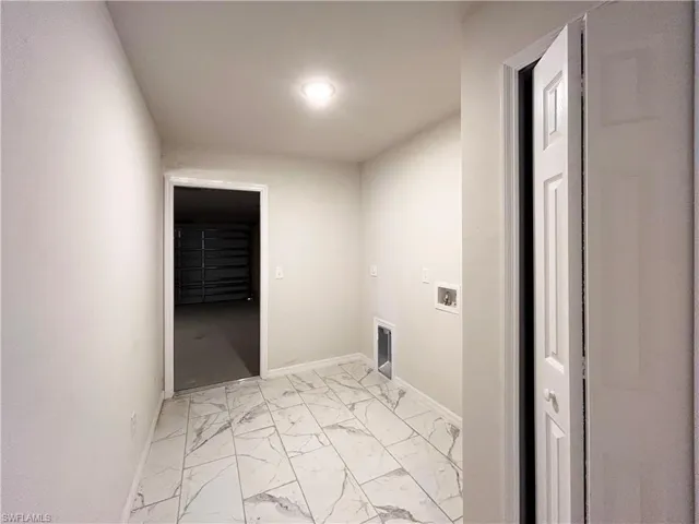 Laundry area with washer hookup and light tile floors