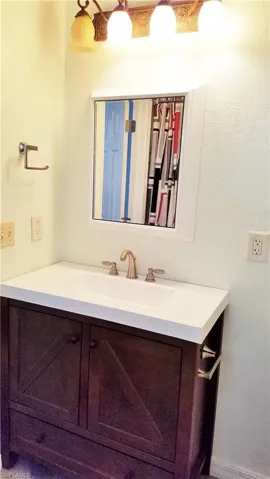 Bathroom featuring vanity and a textured wall