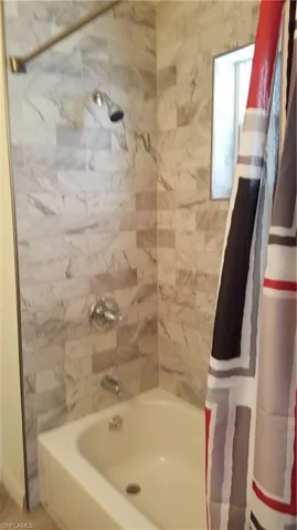 Bathroom with shower / tub combo with curtain