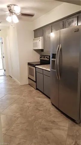 Kitchen featuring fridge, electric range,  and mircrowave
