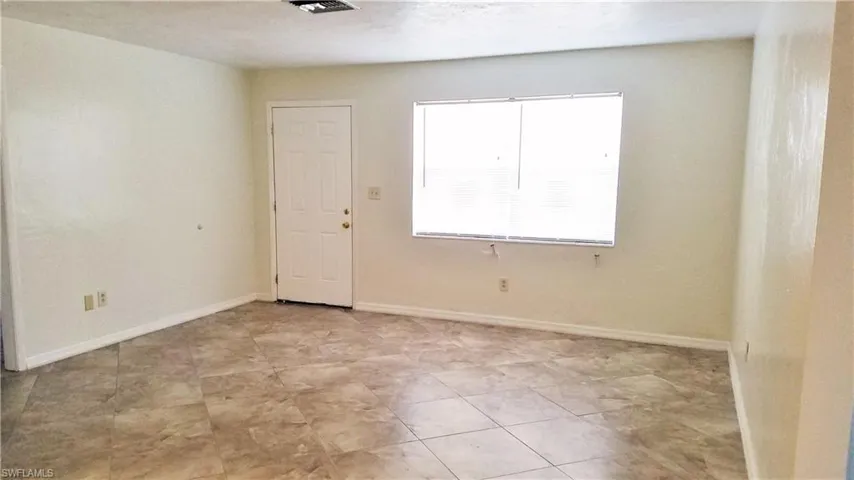 Living room with baseboards and light tile patterned floors