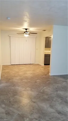 Dining room with ceiling fan and baseboards
