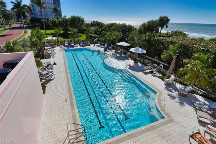 Community pool with a patio and a water view
