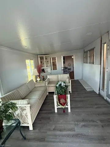 Living area featuring dark wood-style flooring