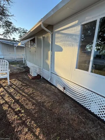 View of side of property with a cooling unit