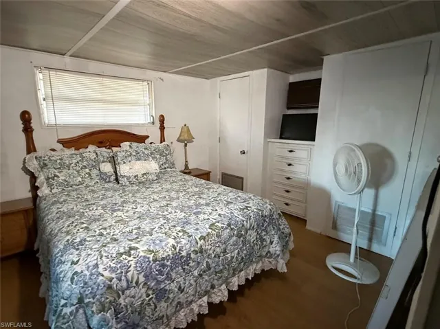 Bedroom featuring wood finished floors, a closet, and wood ceiling