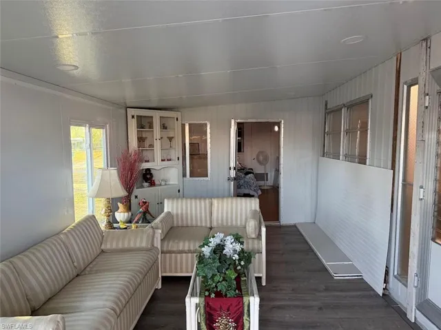 Living area featuring dark wood-type flooring