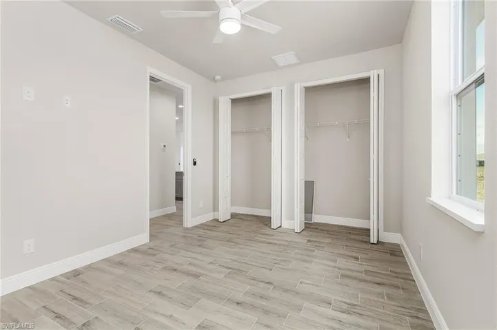 Unfurnished bedroom featuring two closets and ceiling fan Finishes may vary, pictures for illustration purposes only