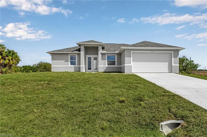 Prairie-style home with a front yard and a garage pictures for illustration purposes only