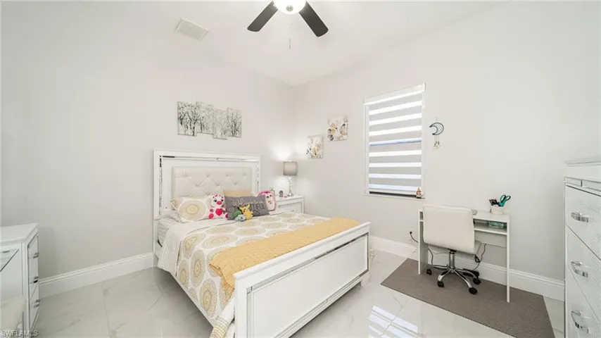 Tiled bedroom with ceiling fan