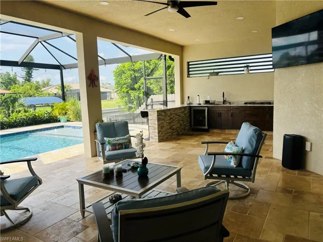View of terrace featuring ceiling fan, a lanai, and sink