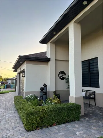 Exterior entry at dusk with a garage