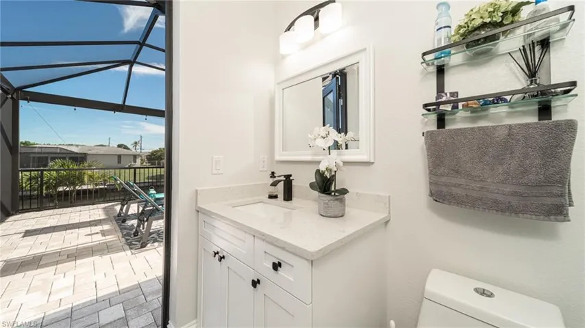 Bathroom featuring toilet and vanity with extensive cabinet space