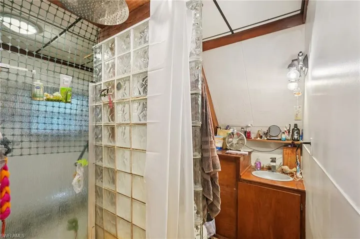 Bathroom with a shower stall and vanity