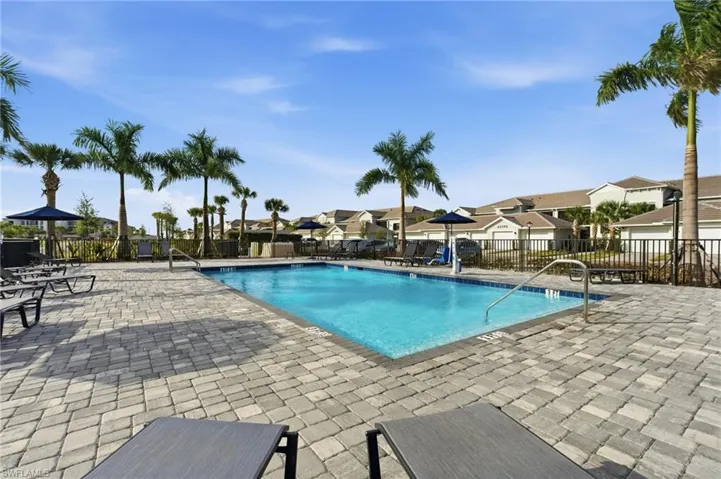 Neighborhood pool with a patio and a residential view