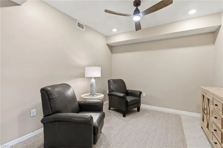 Sitting room with a ceiling fan, recessed lighting, and light tile patterned floors