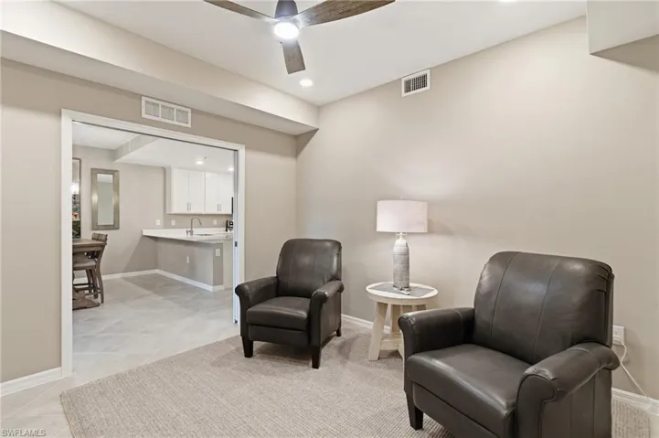 Living area with recessed lighting and ceiling fan