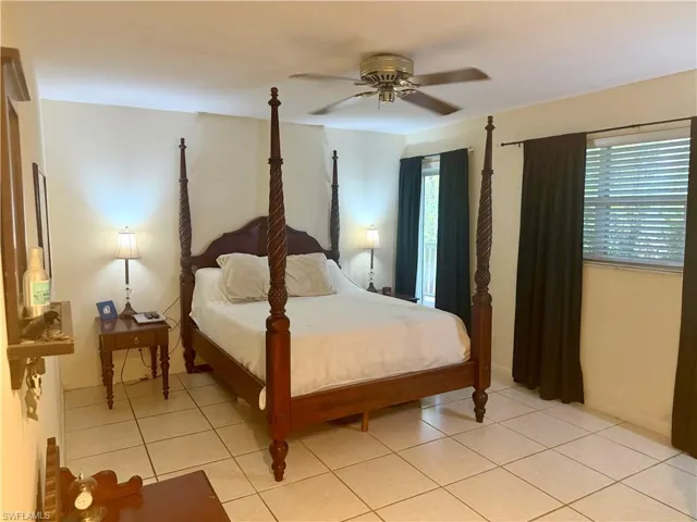 Bedroom with a ceiling fan and light tile patterned flooring