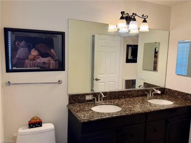 Bathroom with double vanity and hanging lights