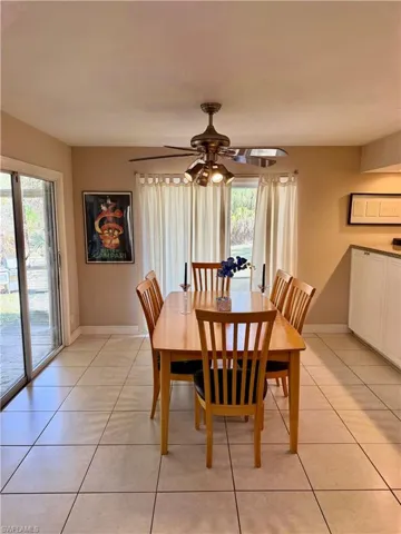 Dining space featuring light tile patterned floors and ceiling fan