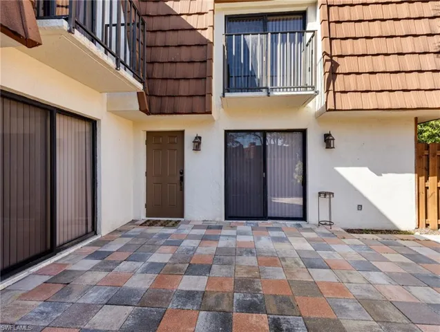 View of exterior entry with a patio area