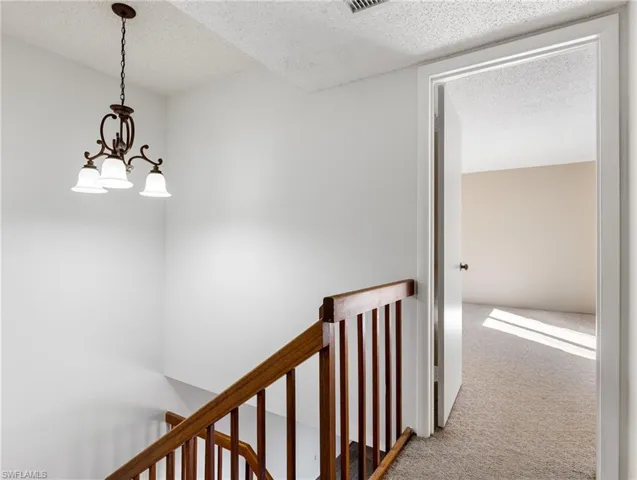 Upstairs Hallway with a chandelier