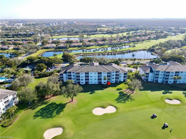 Drone / aerial view of a local golf course and a large body of water