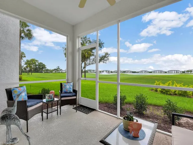 Sunroom featuring a ceiling fan and view of golf course