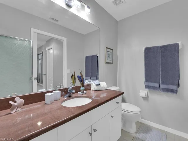 Full bathroom featuring vanity, tile patterned flooring, and a stall shower