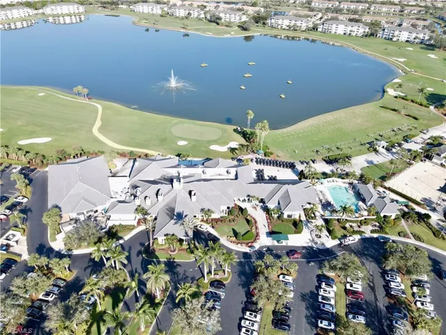 Aerial view of property's location featuring a large body of water and a golf club