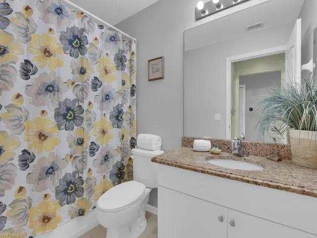 Bathroom featuring vanity, a shower with shower curtain, and tile patterned floors