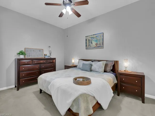 Bedroom with light colored carpet and ceiling fan
