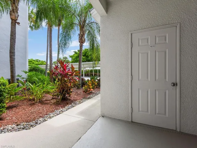Entrance to property with stucco siding