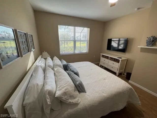 Bedroom with dark wood-style floors and ceiling fan