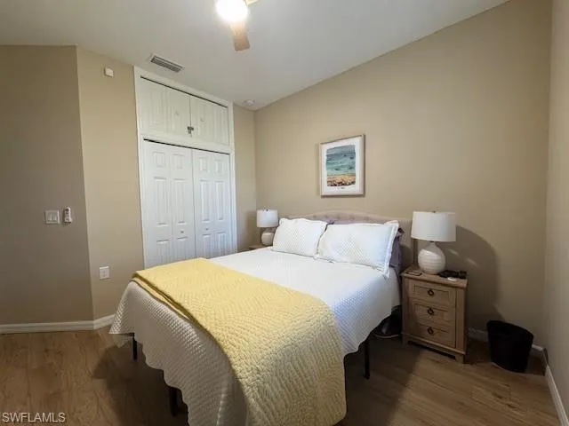 Bedroom featuring a closet, light wood-style flooring, and ceiling fan