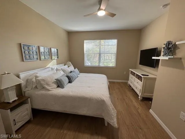 Bedroom featuring dark wood-type flooring and a ceiling fan