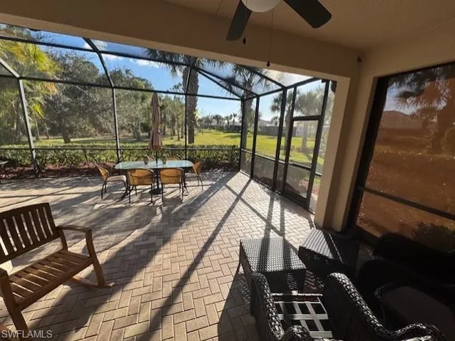 Sunroom with a patio area, a ceiling fan, and outdoor dining area