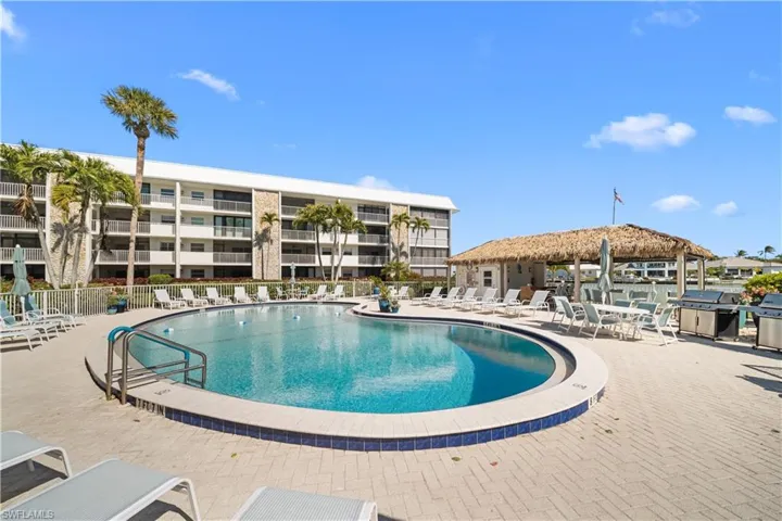 Community pool with area for grilling and a patio