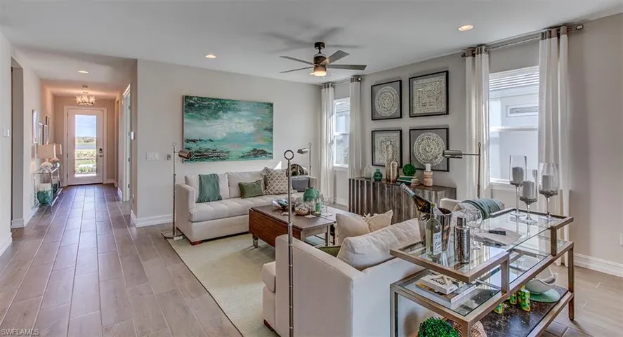 Living room with light wood-type flooring and ceiling fan